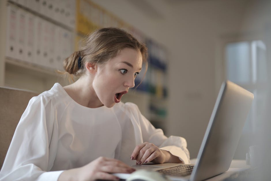 tired person rubbing eyes while working at computer screen showing digital eye strain